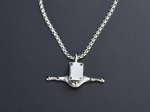 Macro detail of silver titanium steel box chain necklace with geometric pendant on black