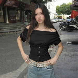 Close-up of black cowl neck crop top featuring three decorative silver metal buttons