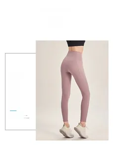 Detail of high waisted yoga pants in dusty rose featuring butt lift stitching and matte fabric