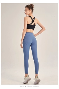 Rear view detail of high-waisted fog blue yoga leggings with peach hip lifting seam design
