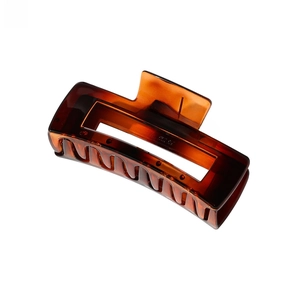 Detail of large amber tortoiseshell hair claw clip with a hollow rectangular resin design