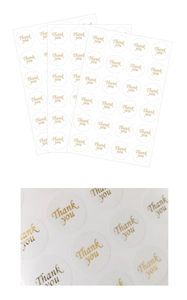 Detail of round thank you stickers with metallic gold lettering for gift packaging