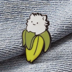 Cute Bananya cat enamel pin with yellow banana design on dark denim background