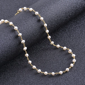 Close-up of irregular freshwater pearl necklace with handcrafted gold wire wrapping
