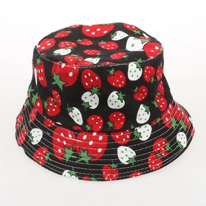 Close-up of kids black sun hat with dense red and white strawberry floral print patterns