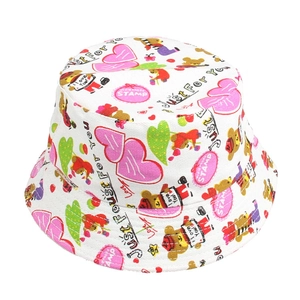 Detail of white kids bucket hat with pink heart, bear prints and decorative text