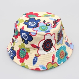 Detailed view of children floral bucket hat with vibrant flower patterns on beige fabric