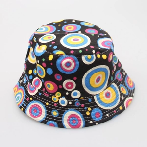 Detail of black bucket hat featuring vibrant multi-colored polka dots and fabric texture