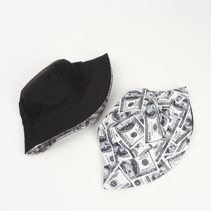 Detail of reversible bucket hat showing minimalist black side and dollar print design