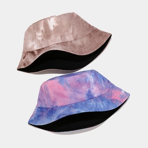 Detail view of tie-dye corduroy bucket hats in brown and blue-pink purple color patterns