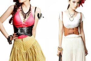 Detail of wide elastic waist corset belt with double metal buckles in black and brown leather
