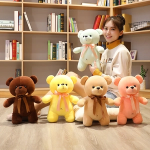 Close-up of colorful teddy bear plush toys with silk ribbon bows in cozy indoor setting