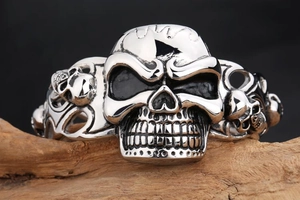 Detailed view of punk rock skull bangle crafted in silver stainless steel on wood