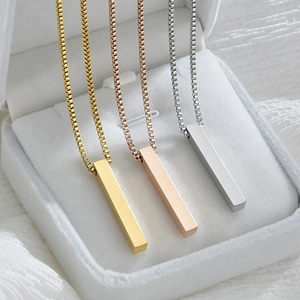 Vertical bar pendant necklaces in gold, rose gold and silver displayed in a jewelry box
