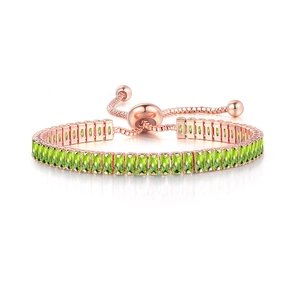 Detail of rose gold adjustable bracelet with rectangular emerald green zircon stones