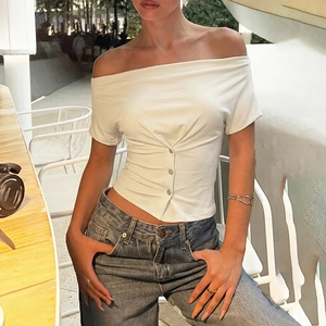 Detail of white off-shoulder T-shirt featuring asymmetric ruching and metal buttons