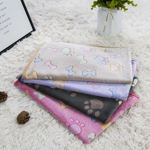Soft flannel pet blankets in beige, purple, grey, and pink with colorful paw prints