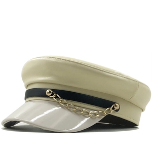 Beige faux leather navy hat with black chain detail and glossy patent leather brim