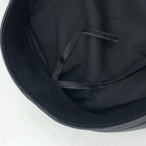 Detail view of the black leather cap interior featuring an adjustable inner satin drawstring