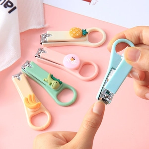 Detailed view of colorful cartoon nail clippers with cute charms and ergonomic plastic handles