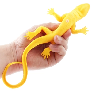 Elastic yellow forest lizard soft rubber toy model shown being stretched by hand