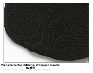 Detailed close-up showing the secure stitching and dense knit texture of the black beanie