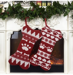Close-up of knit bone-shaped Christmas stockings with snowflake and paw patterns