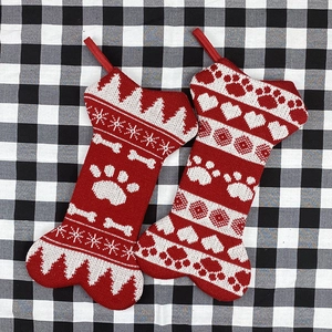 Festive knitted bone-shaped Christmas stockings with snowflakes and paw prints patterns