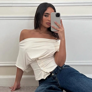 Detail of off-white off-shoulder slim top with side button accents and knit texture