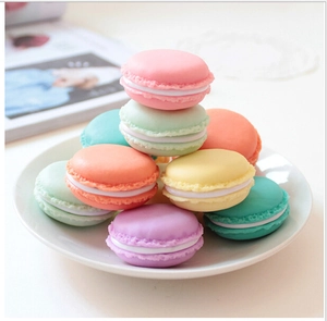 Pastel macaron-style mini jewelry boxes stacked on a white plate for storage
