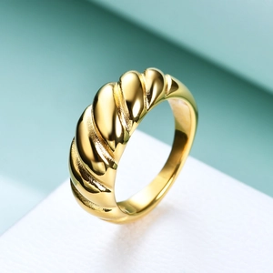 Macro shot of 8mm gold twist croissant ring showing polished steel texture and finish