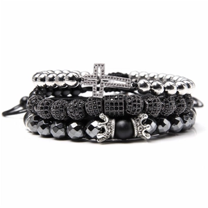 Detail of bohemian natural stone bracelet set featuring micro-pave cross and crown charms