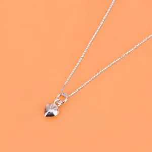 Polished S925 sterling silver heart pendant on a classic box chain with orange background