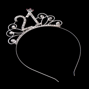 Detail of silver rhinestone 21st birthday headband with sparkling crown and pink accents
