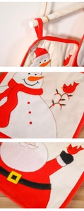 Close-up of Christmas oven mitt details featuring snowman and Santa Claus embroidery