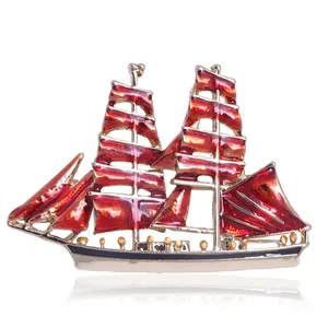 Fashionable sailing boat brooch with red enamel finish and gold-tone alloy base