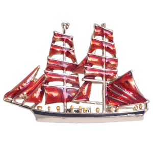 Artistic vintage sailboat brooch with red enamel sails and gold metal detailing