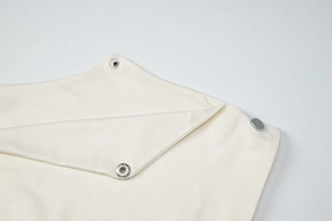 Detailed close-up of premium metal snap buttons and high-density cotton twill fabric