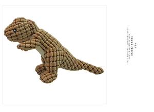Macro detail of the dinosaur dog toy featuring textured tan corduroy fabric and stitching
