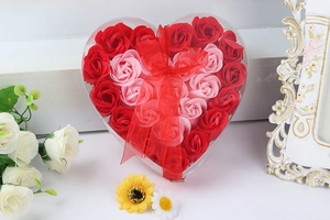 Macro shot of 24 soap rose flowers in heart shaped box with red ribbon for Mother's Day