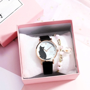 Close-up of cat quartz watch and floral bead bracelet in a pink gift box display