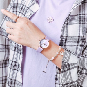 Detailed lifestyle shot of a purple quartz watch for girls with a gold case on wrist