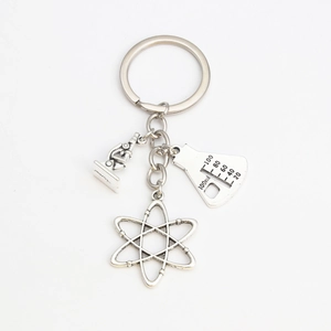 Close-up of teacher keychain with microscope, beaker, and atom science charms