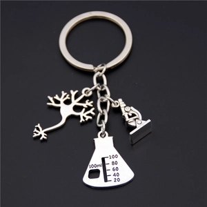 Silver teacher keychain featuring neuron microscope and Erlenmeyer flask charms