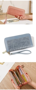 Detailed internal compartments of pink and blue faux leather wallet with wrist strap