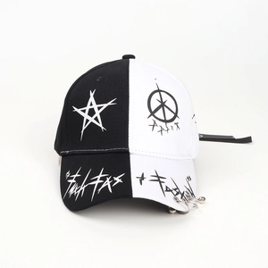 Close-up of black and white baseball cap with metal rings and star graffiti print