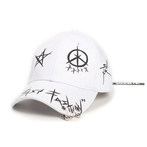 Detail of white baseball cap with metal rings and black graffiti street style design