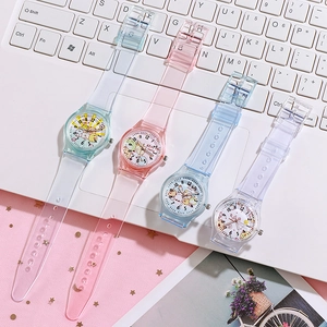 Close-up of colorful cartoon quartz watches with transparent PVC straps on a laptop