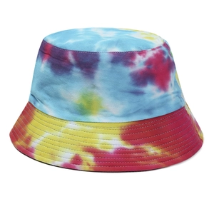 Tie-dye cotton bucket hat with blue and yellow patterns on a clean white background