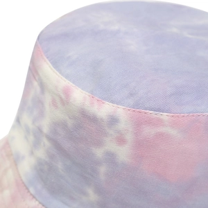 Macro detail of tie-dye cotton fabric texture and fine stitching on a sun bucket hat